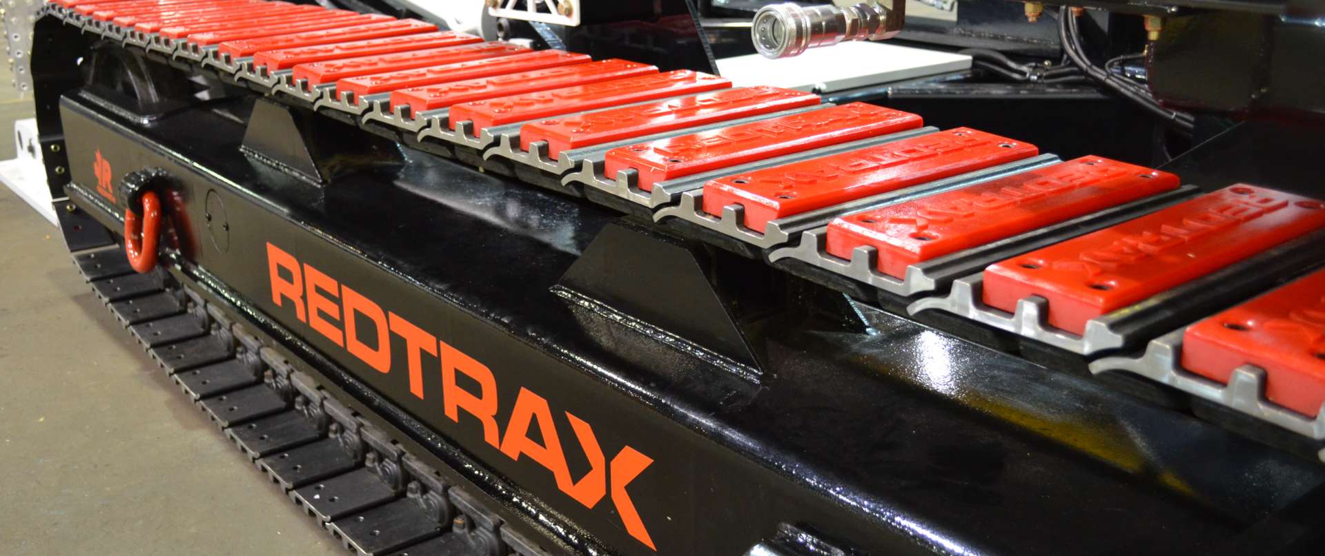 A closeup image of the mobile tracks of a Redtrax, a mobile vehicle to help move drills.